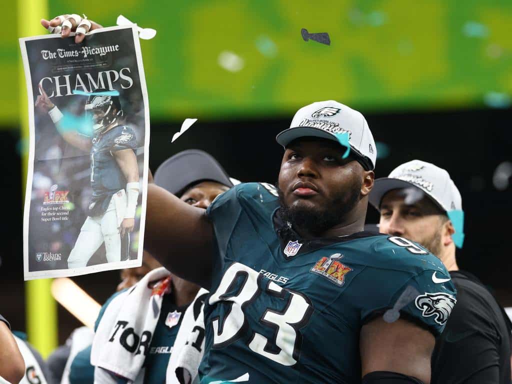 Philadelphia Eagles defensive tackle Milton Williams (93) celebrates on the podium after defeating the Kansas City Chiefs in Super Bowl LIX at Ceasars Superdome.