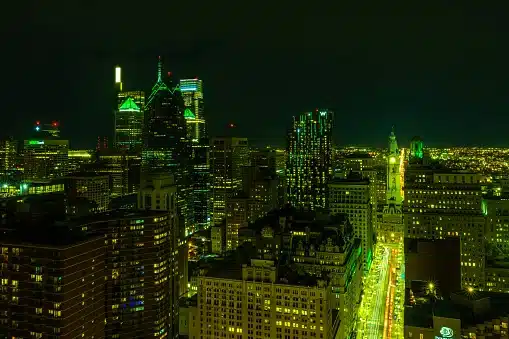 At night, the city lights in Philly shine green to show support for the Eagles football team and their Super Bowl appearance. The skyscrapers in this photo range from One Liberty, Pyramid Club, City Hall, and the W hotel. This was captured from the Penthouse of Arthaus.