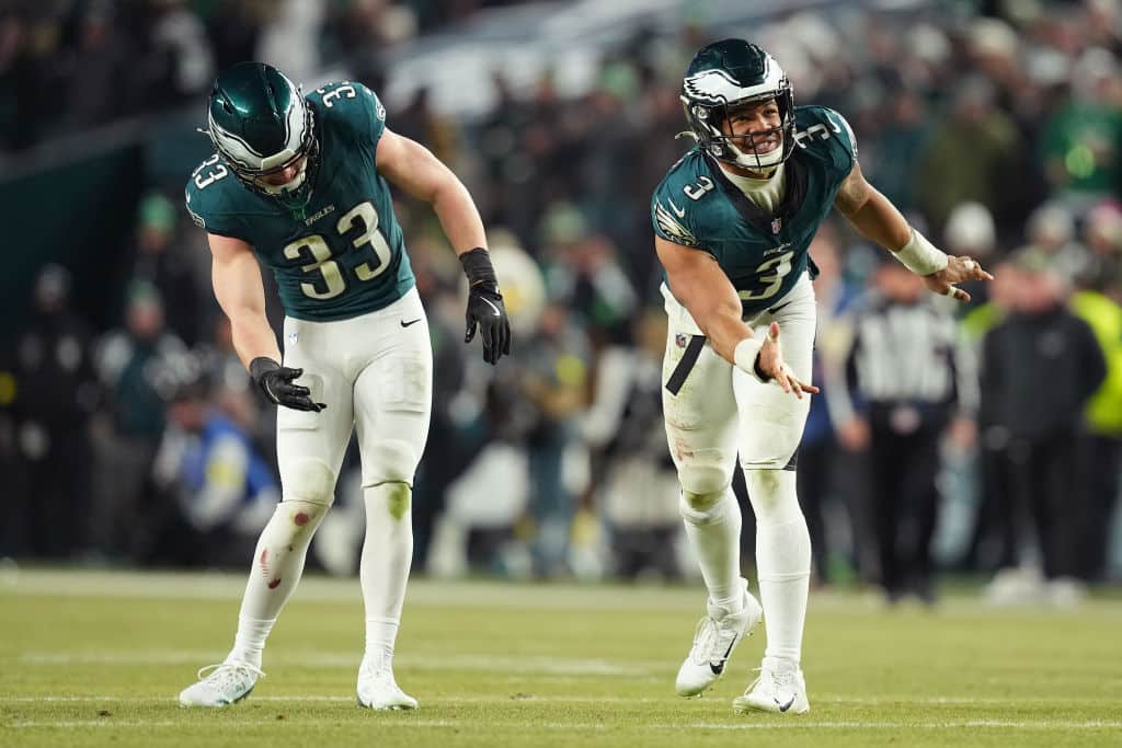 PHILADELPHIA, PENNSYLVANIA - JANUARY 12: Cooper DeJean #33 and Nolan Smith Jr. #3 of the Philadelphia Eagles react during the second half against the Green Bay Packers during the NFC Wild Card Playoff at Lincoln Financial Field on January 12, 2025 in Philadelphia, Pennsylvania.