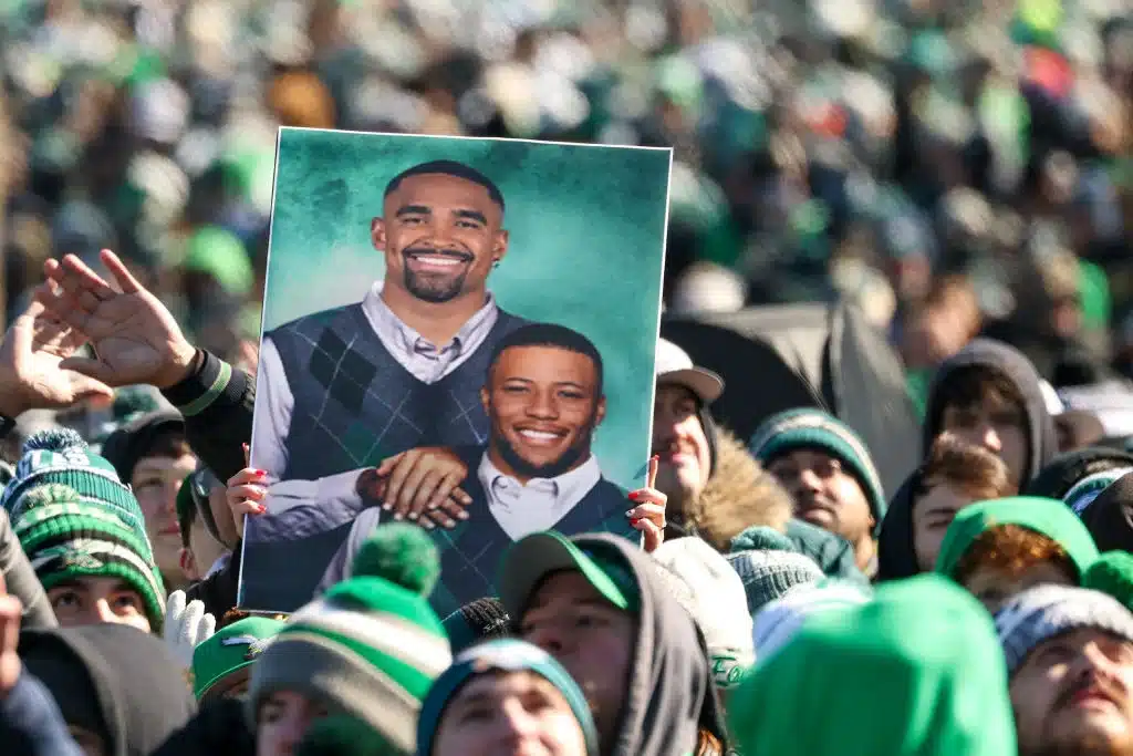Fans celebrate with signage of Saquon Barkley #26 and Jalen Hurts #1 during the Philadelphia Eagles Super Bowl Championship Parade