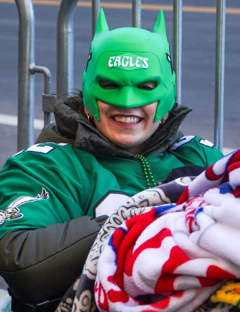 Philadelphia Eagles fan Alyssa Veneziale, from Philadelphia, gets her parade-watching spot at the barricades along South Broad Street ahead of the Eagles’ Super Bowl 59 victory parade