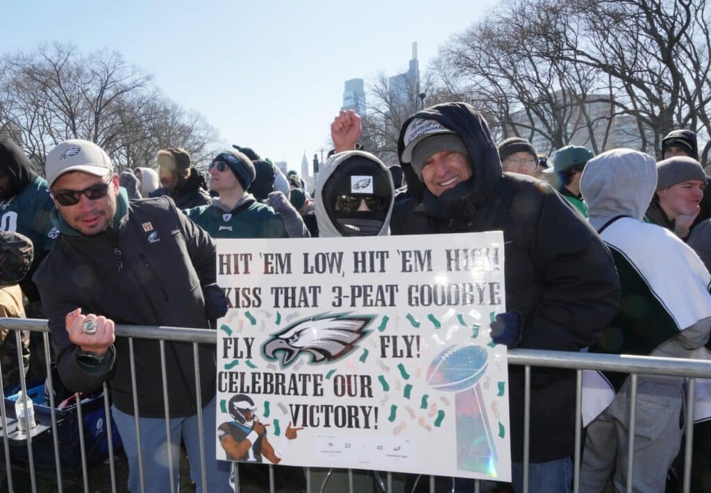 Philadelphia Eagles fans cheer with a homemade sign before the Super Bowl LIX championship parade and rally.