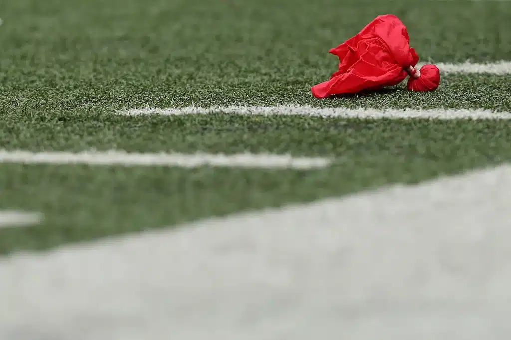 A red challenge flag lays on the field after head coach John Harbaugh of the Baltimore Ravens challenged a play against the Cincinnati Bengals at M&T Bank Stadium on September 27, 2015 in Baltimore, Maryland.