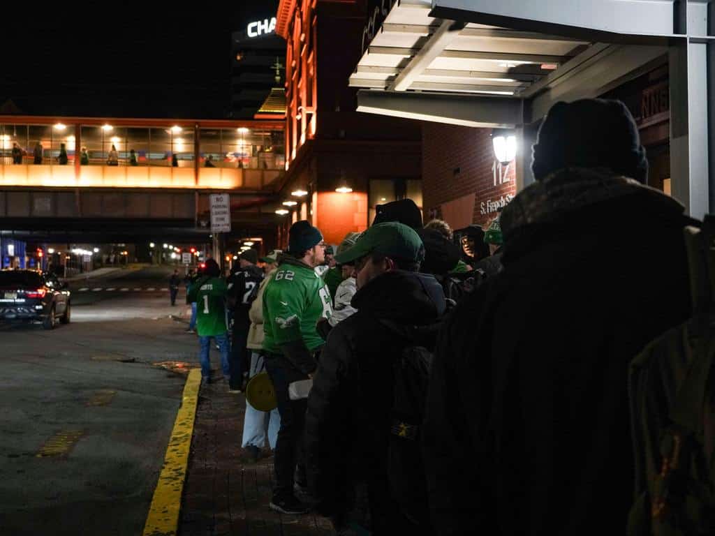 Fans bound for the Philadelphia Eagles Super Bowl parade wait outside the Joseph R. Biden Railroad Station to board the 6:30 a.m train as the 5:30 a.m train, already filling with passengers, is nearly ready to depart on the platform, Friday, Feb. 14, 2025.